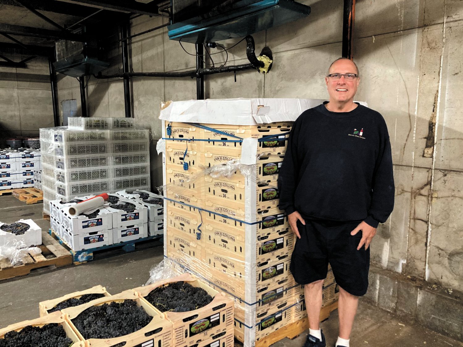 LEARNING TO MAKE WINE AT AGE 10: Anthony Moretti learned to make wine at age 10 from his neighbor George Solitro and started making his own wine at 13. He now imports grapes from California and crushes and presses them into grape juice to sell to customers who produce their own wine.